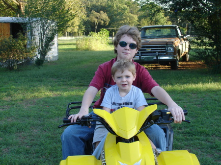 Caine giving Jacob a 4 wheeler ride.