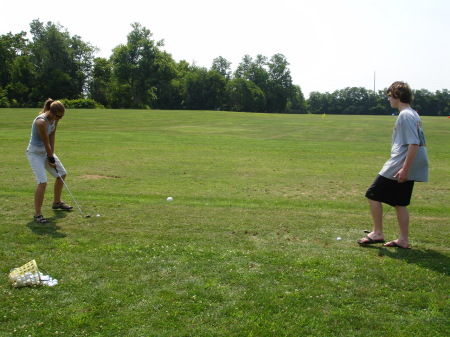 Teaching Jess how to golf.