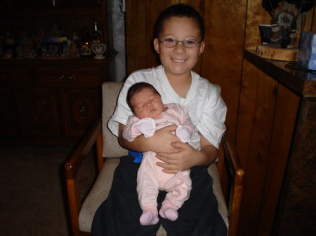My nephew Anthony holding his brand new sister Janelle