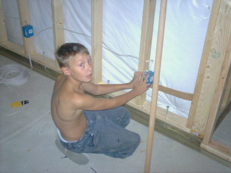 Son Alex helping wire basement