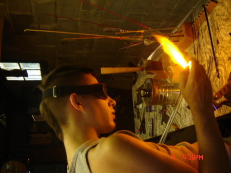 My son blowing glass and/or lampworking.