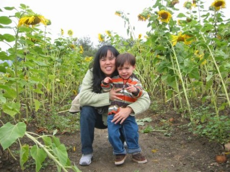 Mom and Luca with sunflowers, October 2005