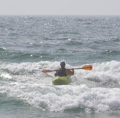 Jen surf-kayaking in NC