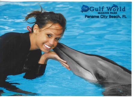Lacey swimming with a dolphin