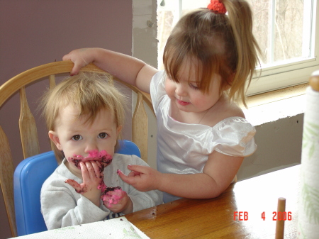 Jordan stealing "pupcake" icing from Alisa's cheek