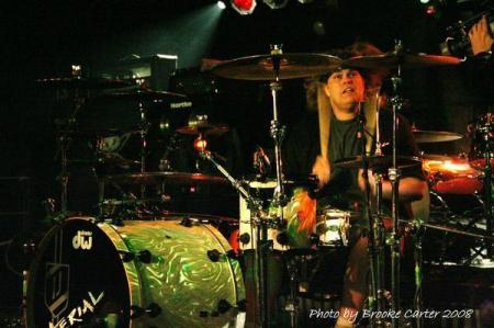 Ivin playing drums with his band