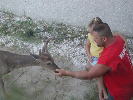 Bryan and Hannah feeding a buck