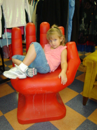 Rebecca in a really cool hand chair.