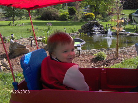 Our Grandson in front of the new pond