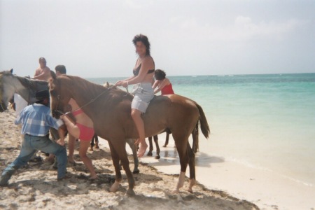Lisa horse-back riding on the Caribbean shores