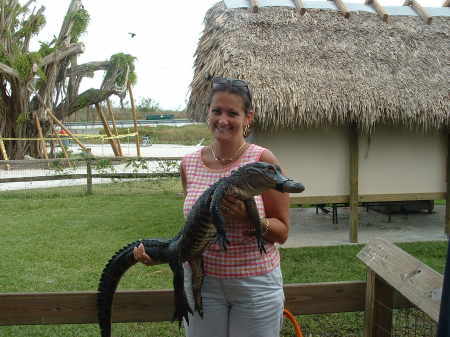 holding Larry, the alligator at the Miami Everglades park