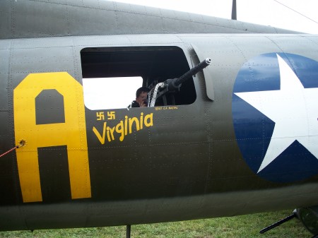 My youngest on a B-17 at air show in a waist gunner spot