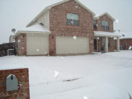 Snowing at my house-03-06-08.Rebecca in front.