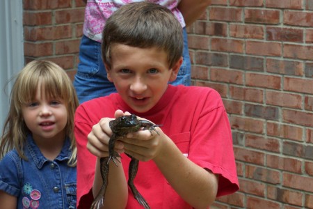 My son Max with the frog his big brother Alec caught with my niece Sara in the background.