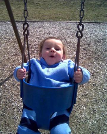 Colin's first ride on a swing.