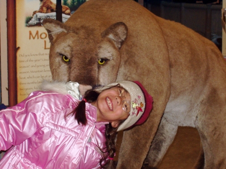 My daughter, Arianna hamming it up with a Mtn Lion