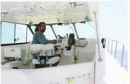 Captain Dave at Helm of 35 Ft. Catamaran