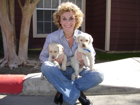 Denise with white lab puppies