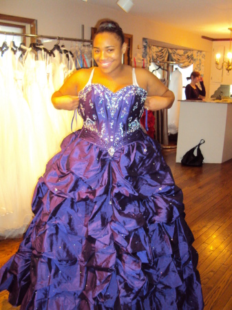 Sha trying on Prom dress to b fitted.