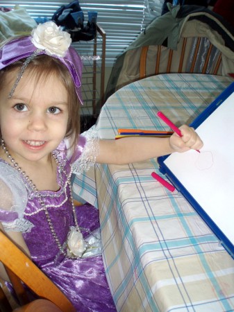 Emily dressing up and drawing a picture.