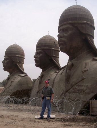Hutchins with Sadam Statutes, Baghdad, Iraq, 2005