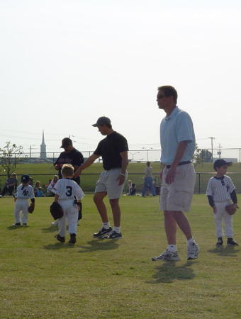 Volunteer Coach in Plano,TX. I'm the adult in the middle, black shirt and grey cap.  We were the Yankees this year and my sons were on the team.