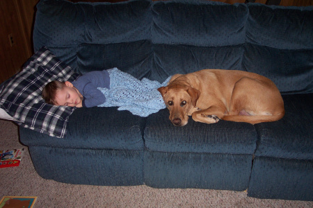 Our dog Jake catching a nap with Ryan.