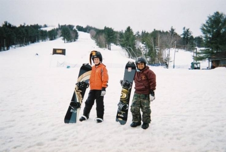 Son snowboard with friend