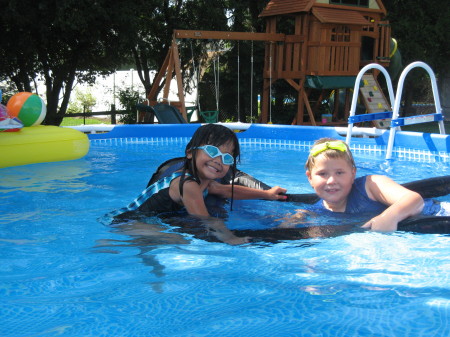 Sydney playing in her pool with a friend