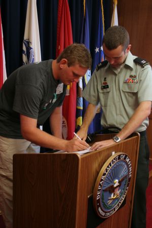 Tommy signing Navy Reserves contract