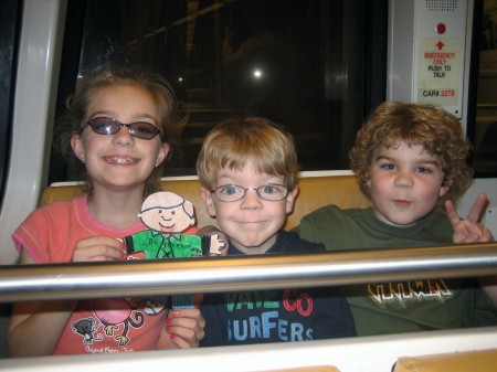 Cara, Brandon & Evan on metro in DC March 2007 w/Amy Sanders' son Evan's Flat Stanley