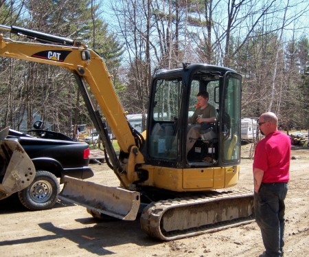 Scott teaching Scotty how to drive excav.