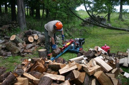 Daddy cutting wood for the fire