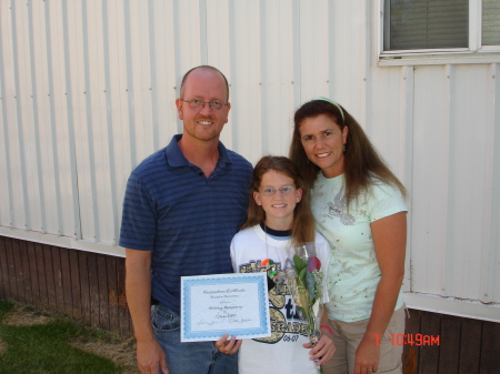 Whittney 6th grade graduation with mom and dad