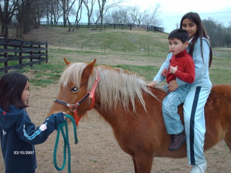 Elizabeth and Stephen riding our pony Becky