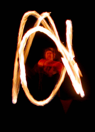 Me spinning fire poi at  a festival.