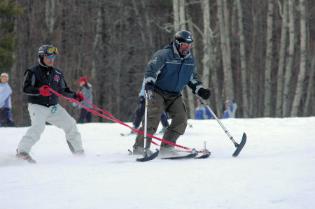 Me teaching a disabled veteran how to ski who was wounded in Iraq