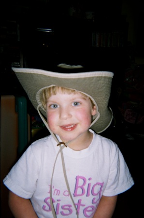 Emily playing with her papi's work hat