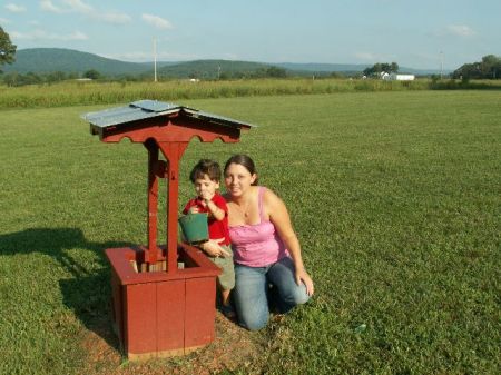 Our grandson and My stepdaughter by our wishing well