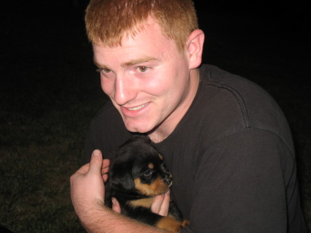 Jeremy holding 1 of our rottweiler puppies.