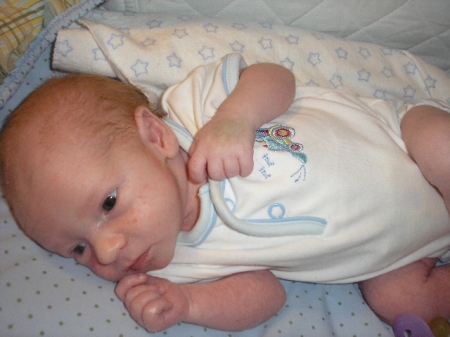 clark at one month old in bassinet