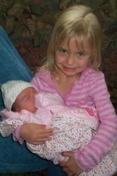 My daughter Logan holding her new cousin