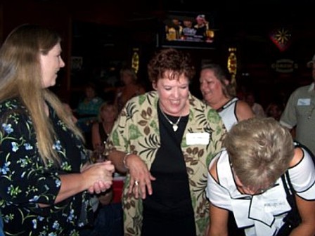 Lynne and Lisa chat while Marilyn signs in