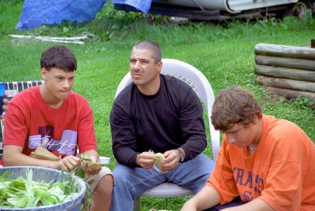 Showing the kids how to shuck corn