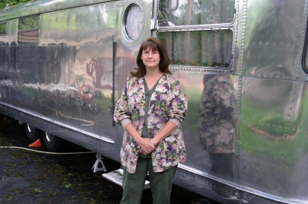 My wife Denise next to our vintage travel trailer.