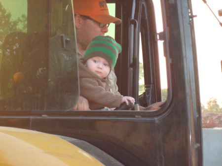 Adam in tractor helping Daddy