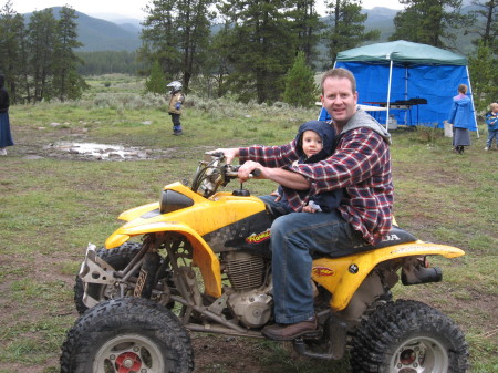 My hubby giving our youngest a ride on the quad!