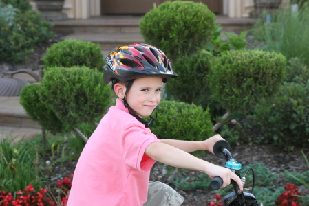 Alexander rides his bike on our front sidewalk!