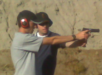 Dustin teaching Shane how to shoot.