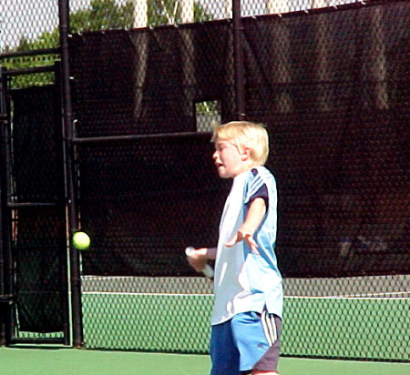 My son Connor playing tennis.